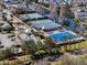 Overhead view of community tennis courts and pool surrounded by lush greenery and neighborhood homes at 9510 Georgian Park Ln # 106, Tampa, FL 33626