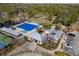 Aerial view of a community pool and gathering space surrounded by trees at 9510 Georgian Park Ln # 106, Tampa, FL 33626