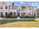 Attractive townhome displaying a well-maintained lawn, red shutters, and covered entry for curb appeal at 9510 Georgian Park Ln # 106, Tampa, FL 33626