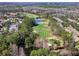 Scenic aerial view of a lush green golf course surrounded by trees and a lake at 9510 Georgian Park Ln # 106, Tampa, FL 33626