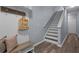 Bright hallway featuring stairs, wood floors, and light gray walls creates a clean and modern look at 9510 Georgian Park Ln # 106, Tampa, FL 33626