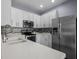 Bright kitchen featuring stainless steel appliances, white cabinetry, and sleek countertops at 9510 Georgian Park Ln # 106, Tampa, FL 33626