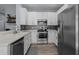 Modern kitchen with stainless steel appliances, white cabinets, and stylish backsplash design at 9510 Georgian Park Ln # 106, Tampa, FL 33626