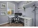 Contemporary home office with a large desk, modern lighting, and floating shelves at 9510 Georgian Park Ln # 106, Tampa, FL 33626