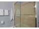 Shower features a sliding glass door and tiled surround at 9510 Georgian Park Ln # 106, Tampa, FL 33626