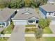 An aerial view of a home showcasing its well-manicured lawn, paver driveway and landscaping at 10132 Tuscan Sun Ave, Riverview, FL 33578