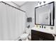 A modern bathroom featuring a shower curtain, a large mirror, and a toilet at 10132 Tuscan Sun Ave, Riverview, FL 33578