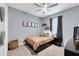 A comfortable bedroom featuring neutral colors, a ceiling fan, and a large window at 10132 Tuscan Sun Ave, Riverview, FL 33578