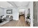 Inviting foyer with light wood floors, neutral walls, and an archway leading to the open-concept living spaces at 10132 Tuscan Sun Ave, Riverview, FL 33578