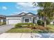 Charming single-story home featuring a well-maintained lawn and a cozy front porch area with stone accents at 10132 Tuscan Sun Ave, Riverview, FL 33578