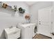 A well organized laundry room featuring white appliances, a sink, and plenty of storage at 10132 Tuscan Sun Ave, Riverview, FL 33578