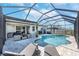 Stunning screened-in pool with lounge chairs and patio furniture, perfect for outdoor entertaining and relaxation at 10132 Tuscan Sun Ave, Riverview, FL 33578