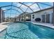 A sparkling backyard pool, enclosed by a screen, offers a refreshing retreat on a sunny day at 10132 Tuscan Sun Ave, Riverview, FL 33578