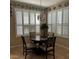 Bright dining area with plantation shutters, an elegant chandelier, and wall decor at 116 Silver Falls Dr, Apollo Beach, FL 33572