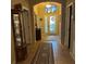 Inviting foyer with tile flooring, decorated glass door and transom window allowing for ample natural light at 116 Silver Falls Dr, Apollo Beach, FL 33572