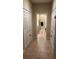 Bright hallway with tile flooring and bathroom view at the end of hall with red patterned rug at 116 Silver Falls Dr, Apollo Beach, FL 33572