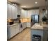 Modern kitchen with white cabinetry, stainless steel appliances, tiled backsplash and spacious countertops at 116 Silver Falls Dr, Apollo Beach, FL 33572