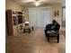 Cozy living room with tile flooring, large windows, glass coffee table and an entertainment center at 116 Silver Falls Dr, Apollo Beach, FL 33572