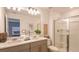 Stylish bathroom features double sinks, a glass-enclosed shower, and modern fixtures at 11828 Glenside Ter, Palmetto, FL 34221