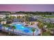 Aerial view of a community pool featuring lounge chairs and beautiful landscaping in a new community at 11828 Glenside Ter, Palmetto, FL 34221