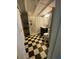 Bathroom features black and white checkerboard floor, shower and shelving at 12 Braden Castle Dr, Bradenton, FL 34208