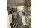 Kitchen featuring an island, stainless steel refrigerator, white cabinets and drawers, and patterned flooring at 12 Braden Castle Dr, Bradenton, FL 34208