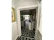 A glimpse into the kitchen area, featuring a stainless steel refrigerator, island, and patterned flooring at 12 Braden Castle Dr, Bradenton, FL 34208