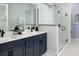 Bathroom with dual sinks, modern fixtures, and a glass shower at 12233 New Tranquility Path, Venice, FL 34293