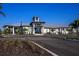 Exterior shot of a modern clubhouse featuring a metal roof and nicely landscaped grounds at 12233 New Tranquility Path, Venice, FL 34293