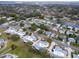 Aerial view shows single Gathering home with mature landscaping in a quiet neighborhood at 1227 Queen Anne Dr # C, Palm Harbor, FL 34684