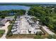 Aerial view of an RV park featuring numerous RVs parked in designated slots with a lake and wooded area in the background at 1227 Queen Anne Dr # C, Palm Harbor, FL 34684