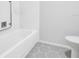 Bathroom featuring gray and white patterned tile flooring and a shower/bath at 1227 Queen Anne Dr # C, Palm Harbor, FL 34684