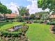 Clubhouse entrance has manicured landscaping and a stately entrance at 1227 Queen Anne Dr # C, Palm Harbor, FL 34684