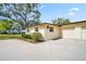 Single story home with a two-car garage and well-maintained driveway on a sunny day at 1227 Queen Anne Dr # C, Palm Harbor, FL 34684