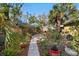 Lush backyard with stone pathway, umbrella table, and variety of plants and trees creates a tranquil oasis at 123 17Th Se Ave, St Petersburg, FL 33701