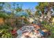 Cozy backyard patio featuring hexagon tile, outdoor seating, mature trees, and a vibrant garden at 123 17Th Se Ave, St Petersburg, FL 33701