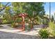 Beautiful backyard patio with brick paving, pergola with wicker seating, and lush landscaping at 123 17Th Se Ave, St Petersburg, FL 33701