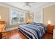 Comfortable bedroom featuring a large window, hardwood floors, and a blue striped comforter at 123 17Th Se Ave, St Petersburg, FL 33701