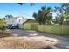 Back of house featuring detached garage and parking area surrounded by lush vegetation and fencing at 123 17Th Se Ave, St Petersburg, FL 33701