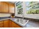 Well-lit kitchen with a stainless steel sink, granite countertops, and wood cabinetry at 123 17Th Se Ave, St Petersburg, FL 33701