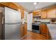 Cozy kitchen featuring stainless steel appliances, granite countertops, and wood cabinetry at 123 17Th Se Ave, St Petersburg, FL 33701