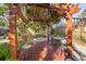 Relaxing backyard pergola with a wooden deck, wicker seating, and lush tropical foliage at 123 17Th Se Ave, St Petersburg, FL 33701