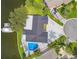 Aerial view of renovated home and pool on waterfront property with dock and lush tropical landscaping at 1514 Sea Gull S Dr, St Petersburg, FL 33707