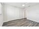 Spacious bedroom with gray wood-look tile flooring and a large closet at 1514 Sea Gull S Dr, St Petersburg, FL 33707