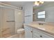 Bathroom featuring tiled shower, toilet, and vanity with integrated sink and mirror at 1531 Council Dr, Sun City Center, FL 33573