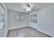 Bedroom featuring neutral paint, ceiling fan, sleek gray flooring, and mirrored closet at 1531 Council Dr, Sun City Center, FL 33573