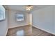 This bedroom features wood-look floors and a window with neighborhood views at 1531 Council Dr, Sun City Center, FL 33573