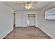 This bedroom features wood-look floors, a ceiling fan, a closet and neighborhood views at 1531 Council Dr, Sun City Center, FL 33573