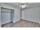 Bedroom featuring neutral paint, ceiling fan, sleek gray flooring, and closet at 1531 Council Dr, Sun City Center, FL 33573