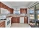 This kitchen boasts wood cabinetry, new appliances, and access to the cozy screened-in porch through sliding glass doors at 1531 Council Dr, Sun City Center, FL 33573